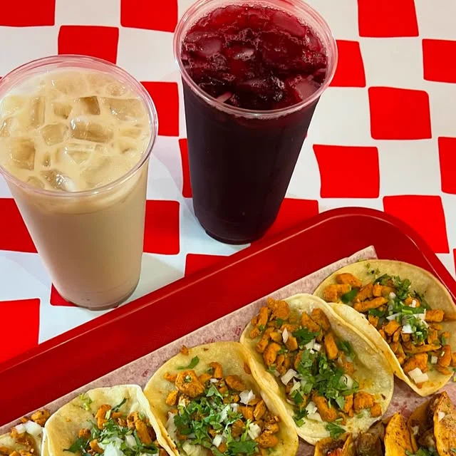 Horchata and jamaica with a tray of tacos