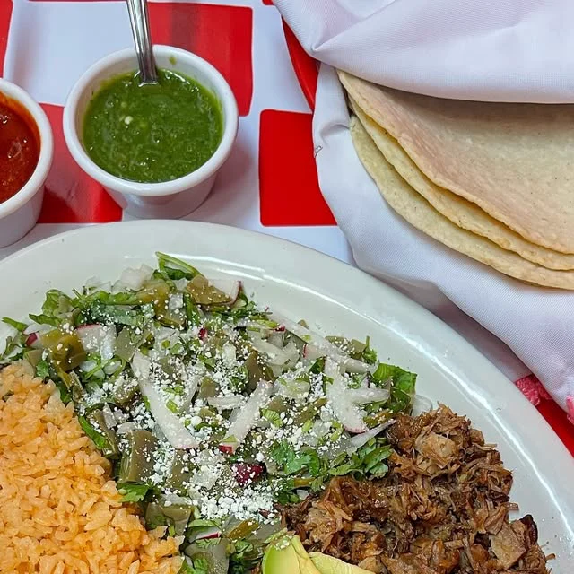 Carnitas plate with rice, nopales salad and tortillas