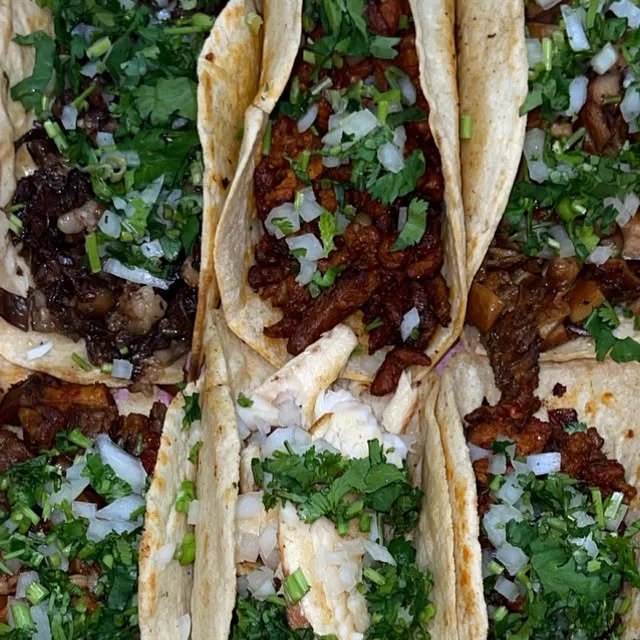 Tacos topped with onion and cilantro